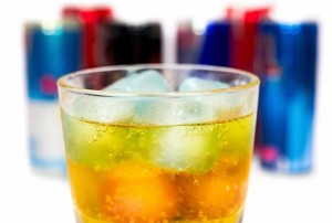 glass with ice and energy drinks on the background